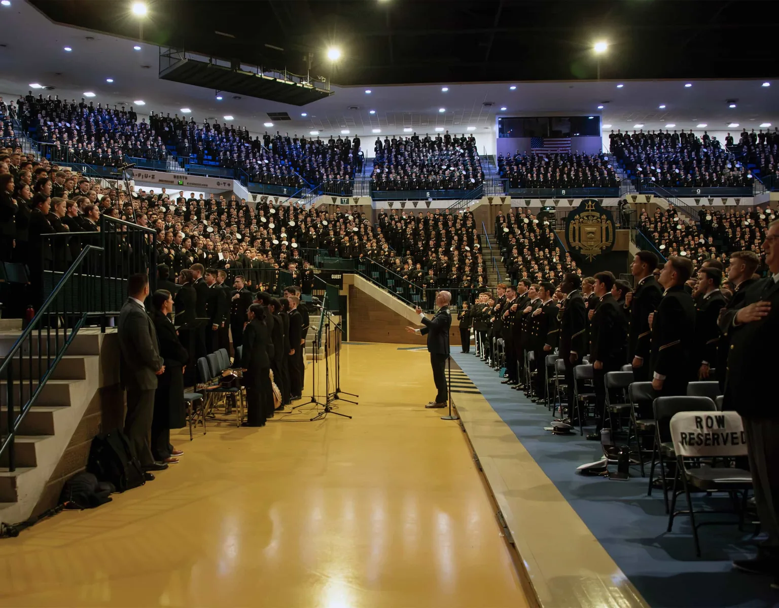 A speaker on the USNA Alumni Hall Arena Floor