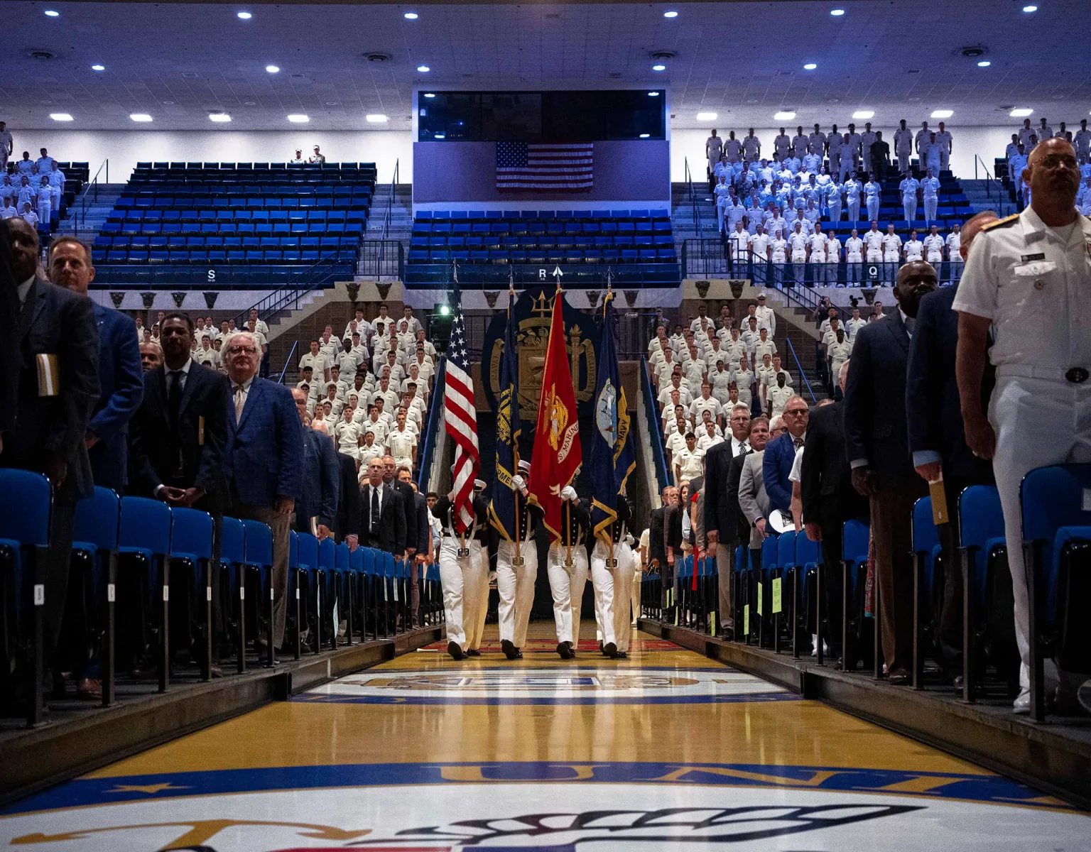 A procession of midshipmen carrying flags