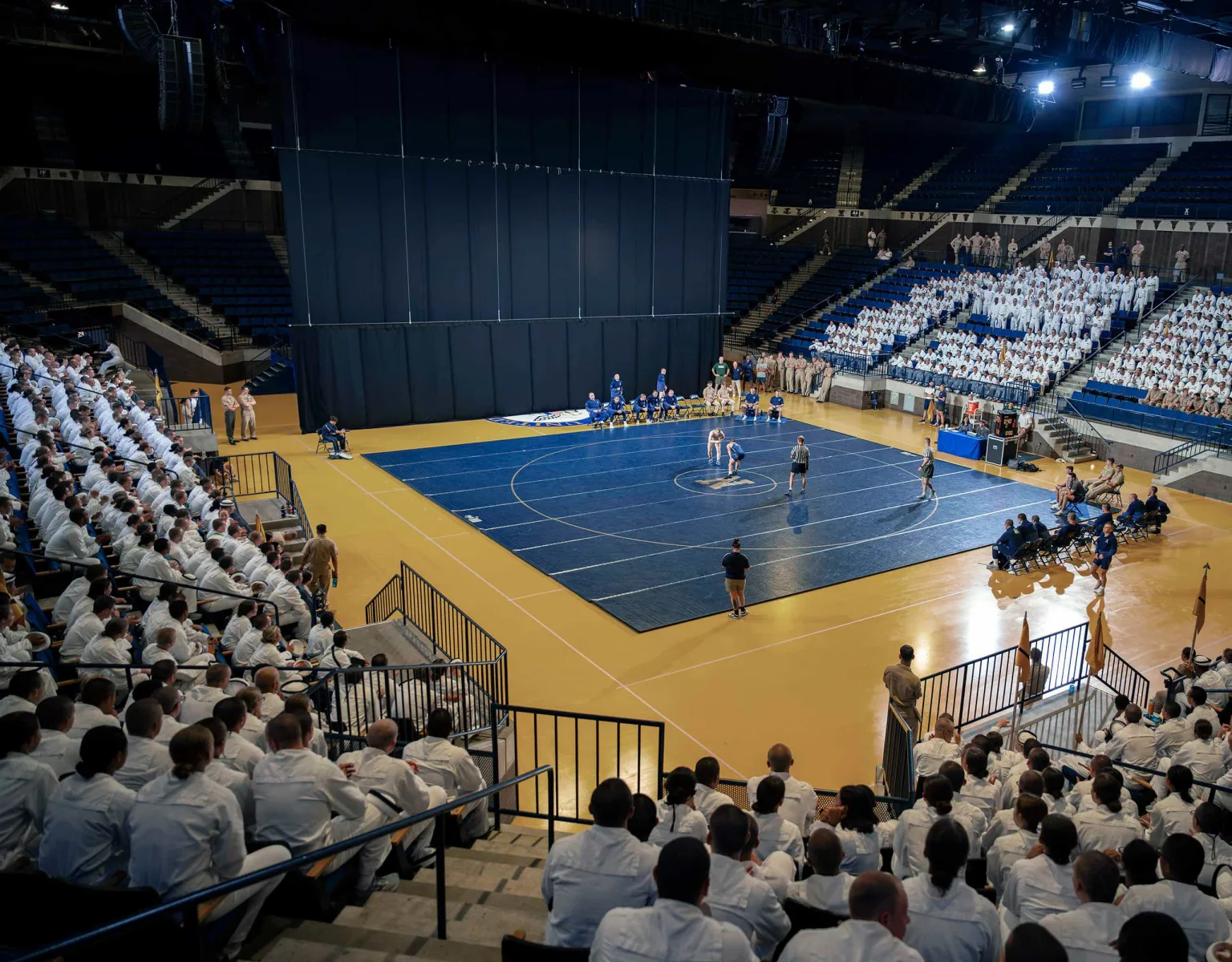 A wrestling match on the USNA Alumni Hall Arena Floor