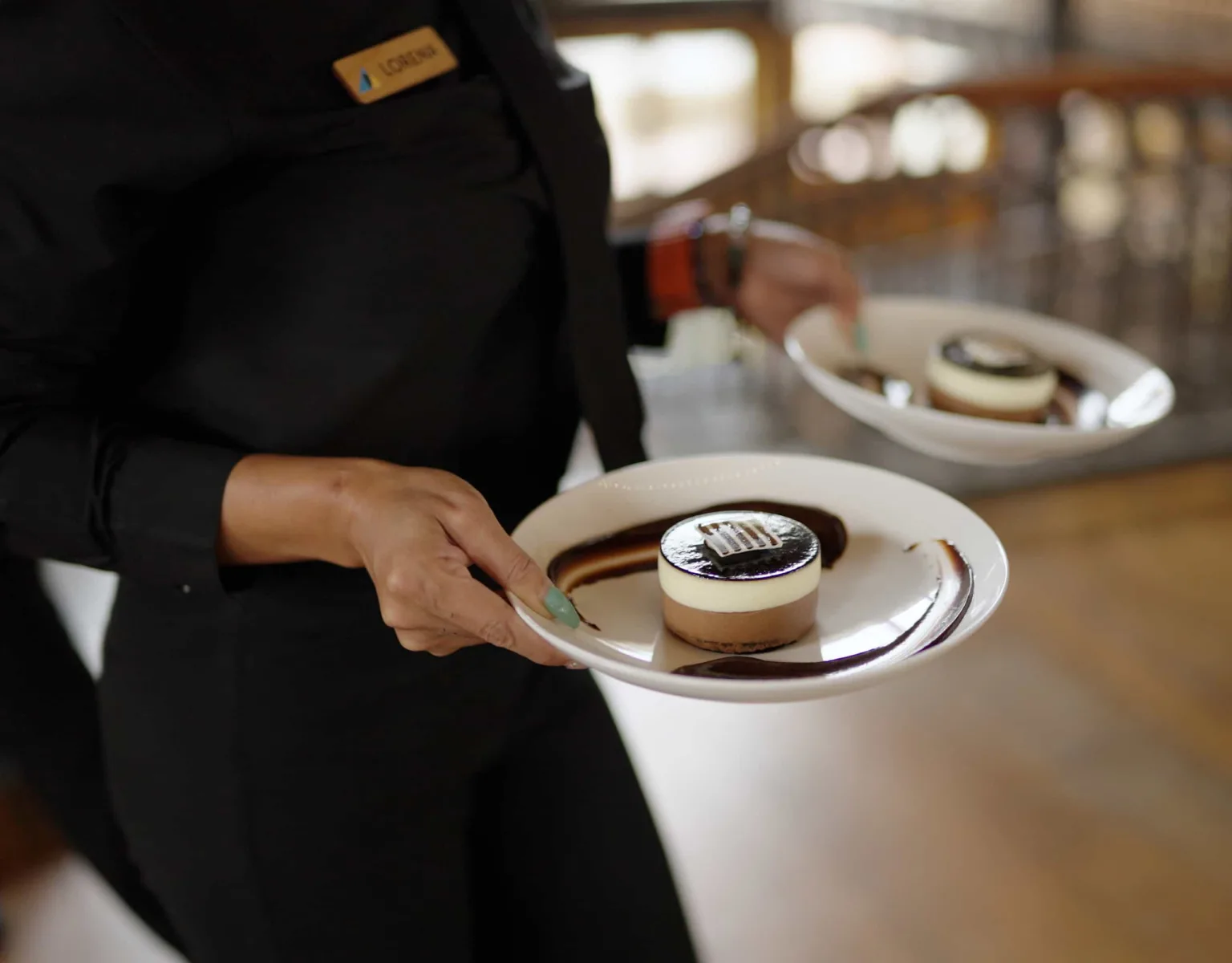 A server carrying plates of desserts