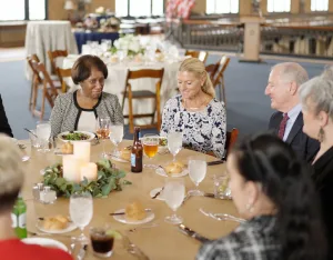 Guests seated around a table having a discussion