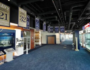 Athletic banners hanging in the building rafters with various display cases on the floor