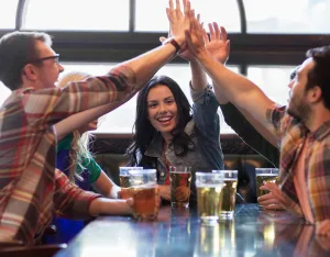 A group of friends with beverages at a table