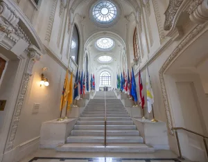Marble staircase lined with flags inside Mahan Hall
