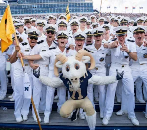 Midshipmen at a football game with the USNA mascot